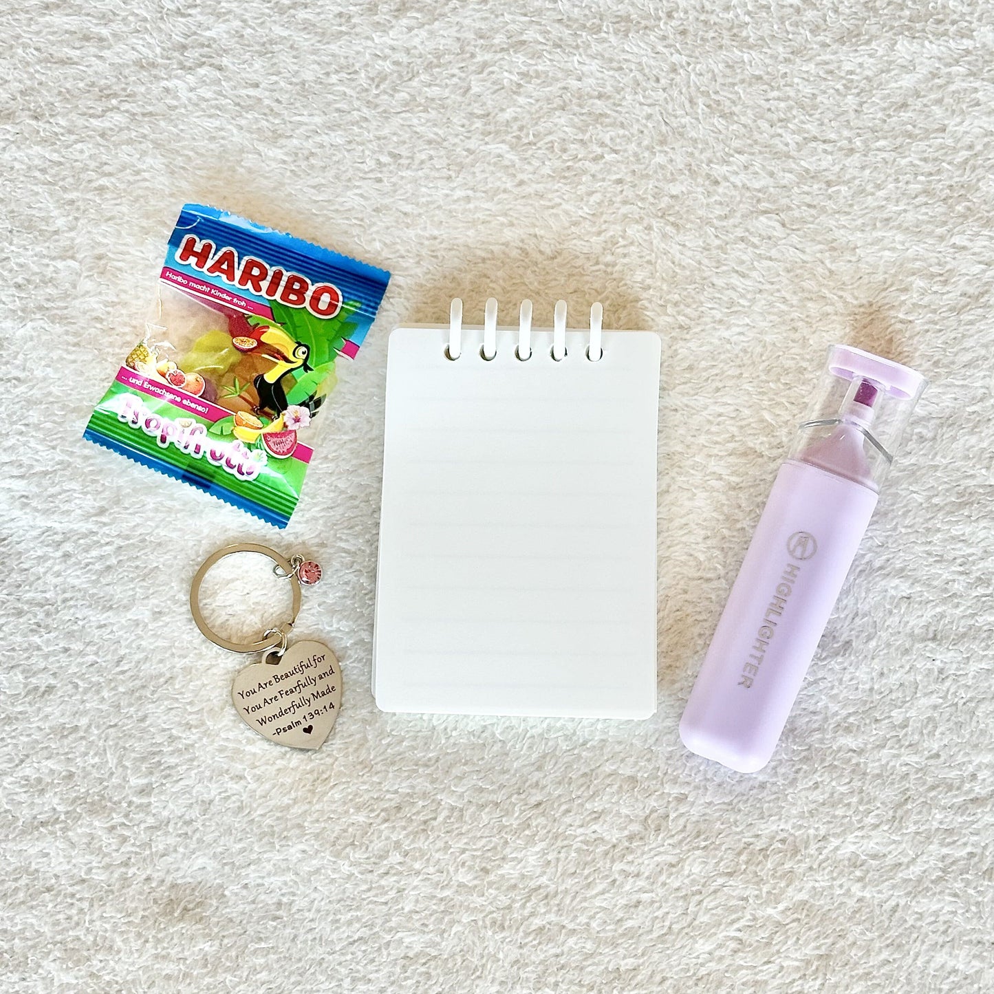 a bible inspired keychain for christians with a little mini notebook